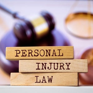 A collection of wooden blocks displaying the phrase ''Personal Injury Law'', - Brian Moore Injury Law